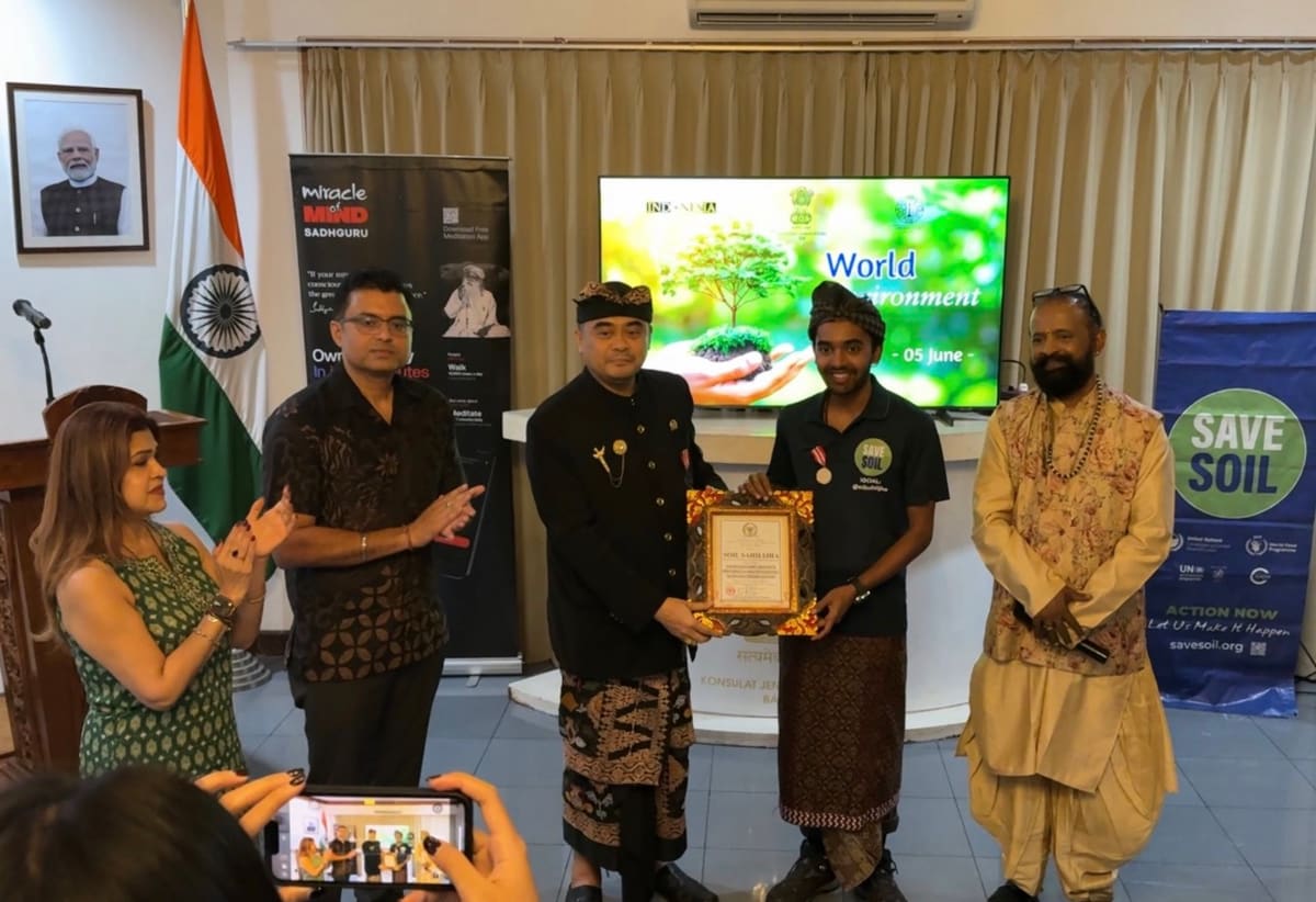 Sahil Jha receiving the Honorary Bali Medal and a framed certificate from Gusti Arya Wedakarna at the Consulate General of India in Bali